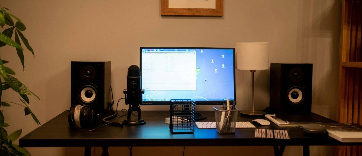 A well-organized modern home office desktop setup featuring technology essentials and accessories.
